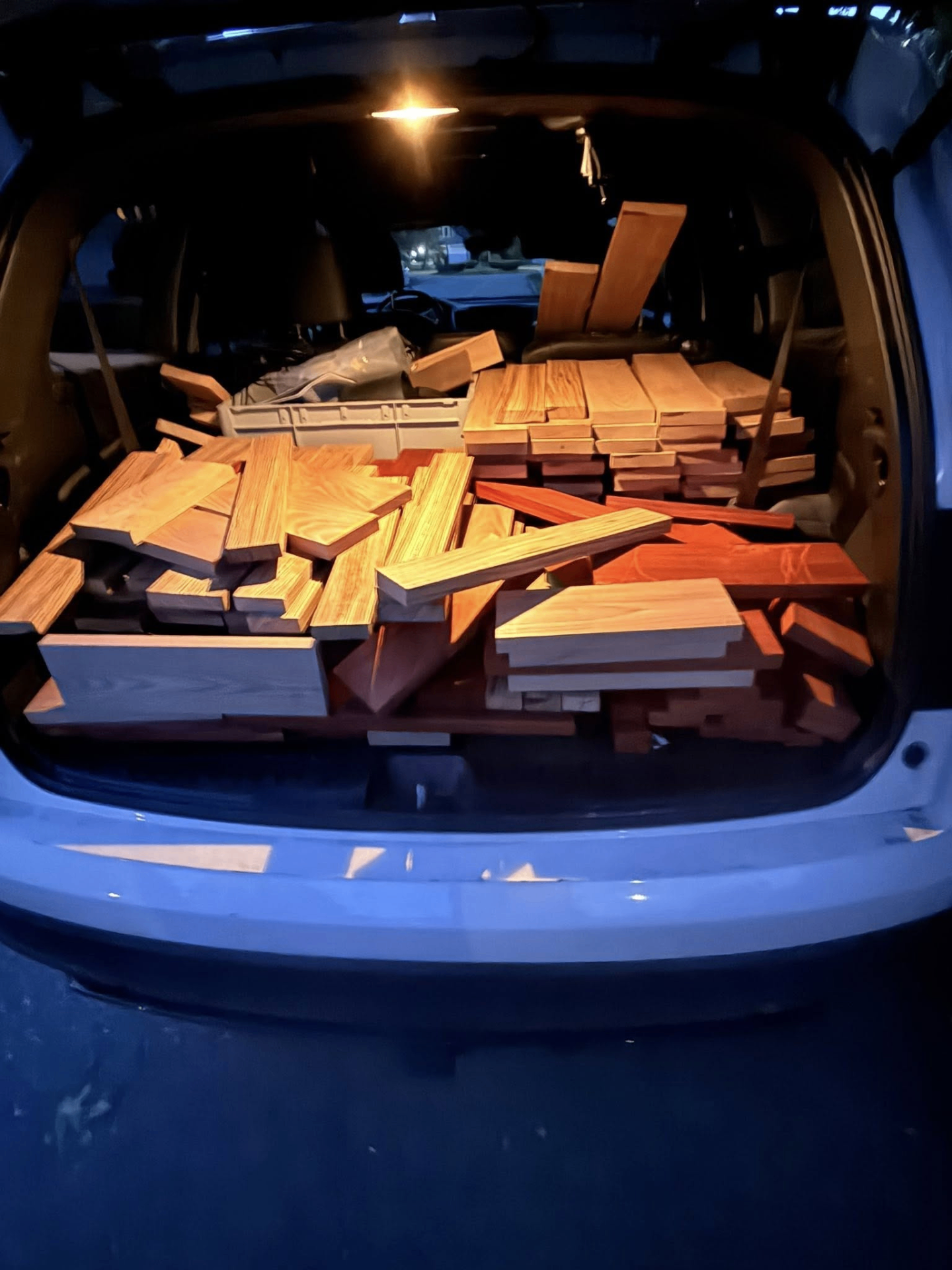 A van loaded with freshly milled hardwood boards from the workshop