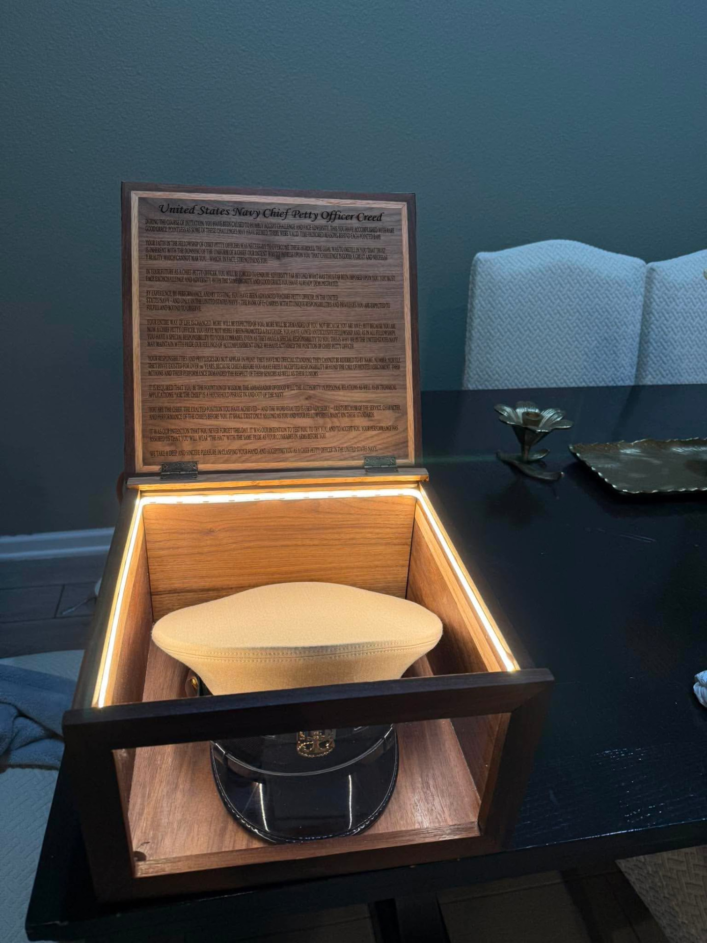 Open hat case showing the engraved Chief Petty Officer Creed in the lid