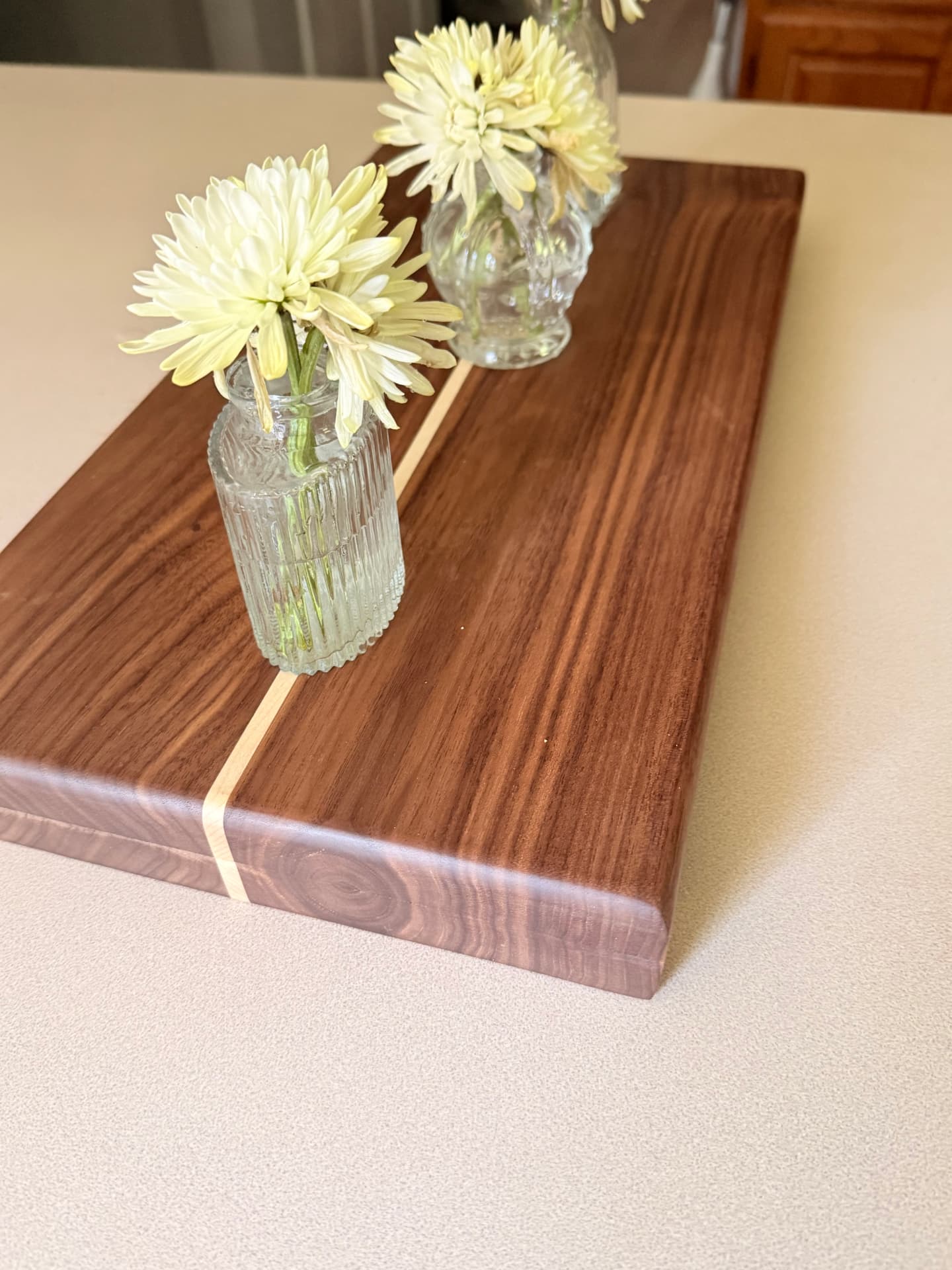 Walnut table riser with maple inlay