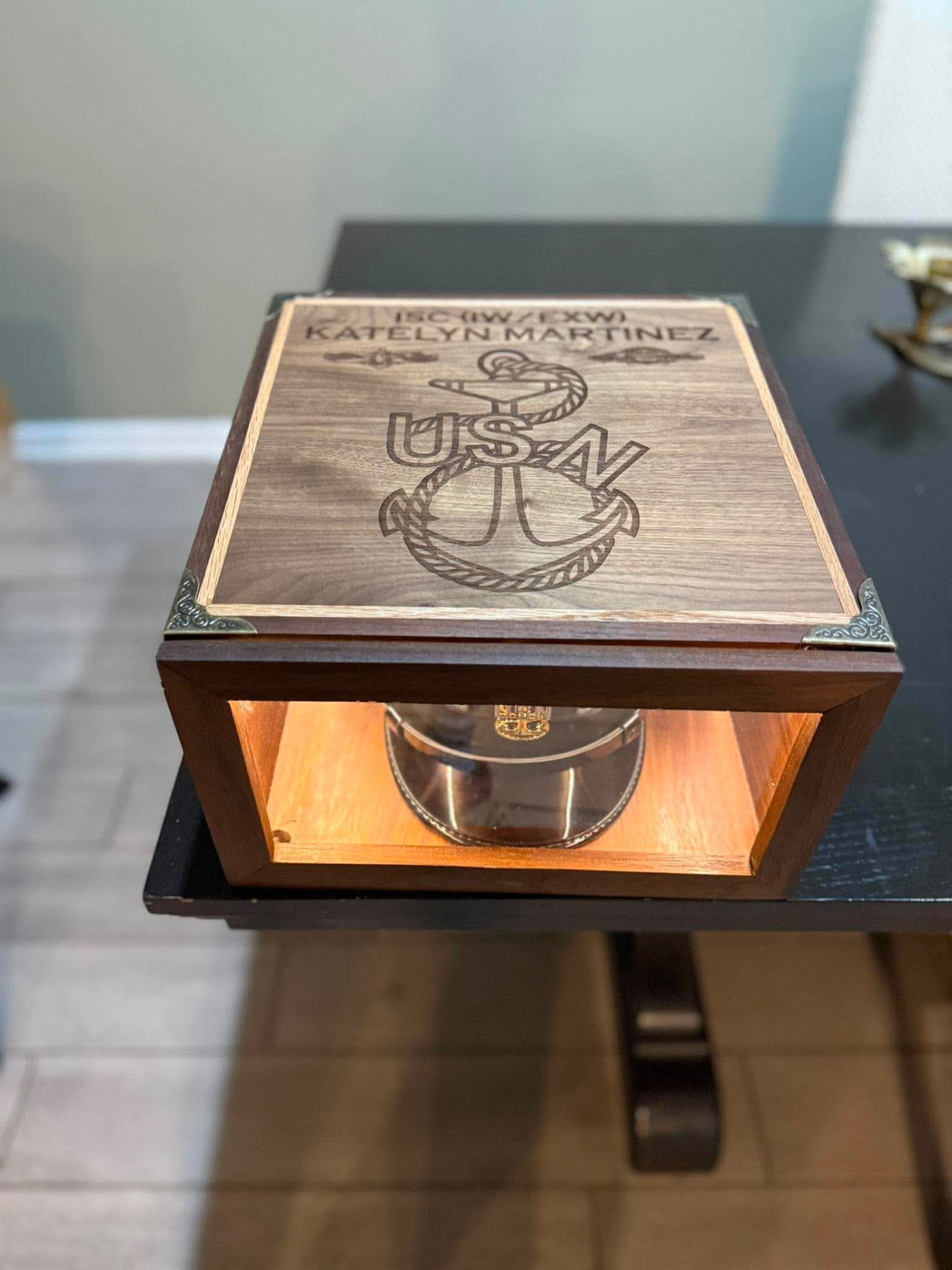 Closed walnut hat display case engraved with USN anchor and Katelyn Martinez