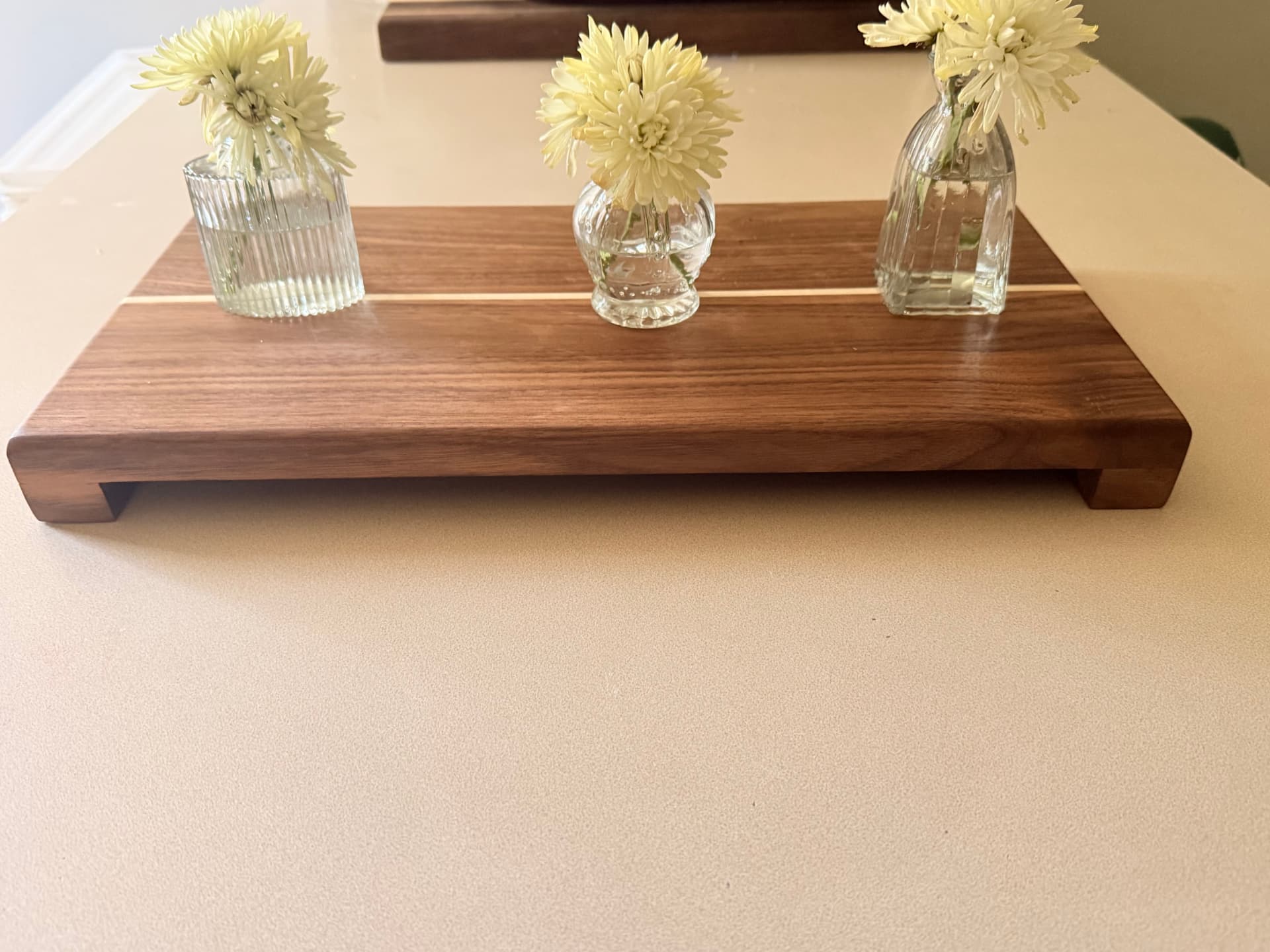 Front view of the footed walnut table riser